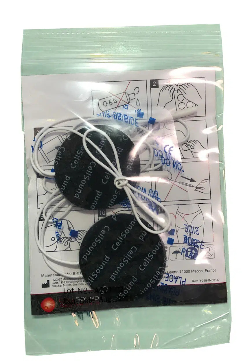 Sealed package containing two round black TENS electrode pads with white lead wires over instruction sheet