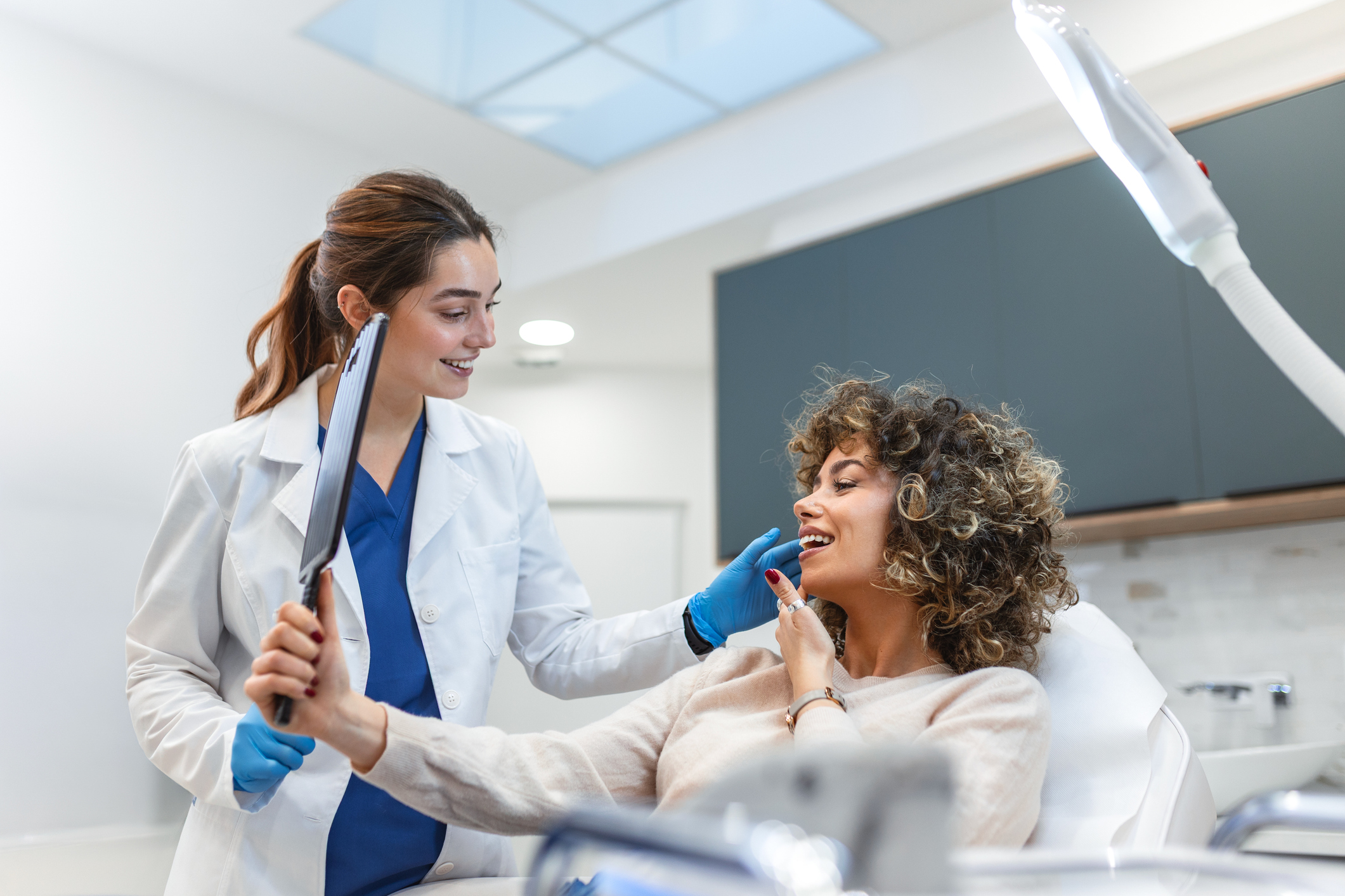 A provider and patient reviewing a regenerative skin care treatment plan for texture, tone, and laxity concerns.
