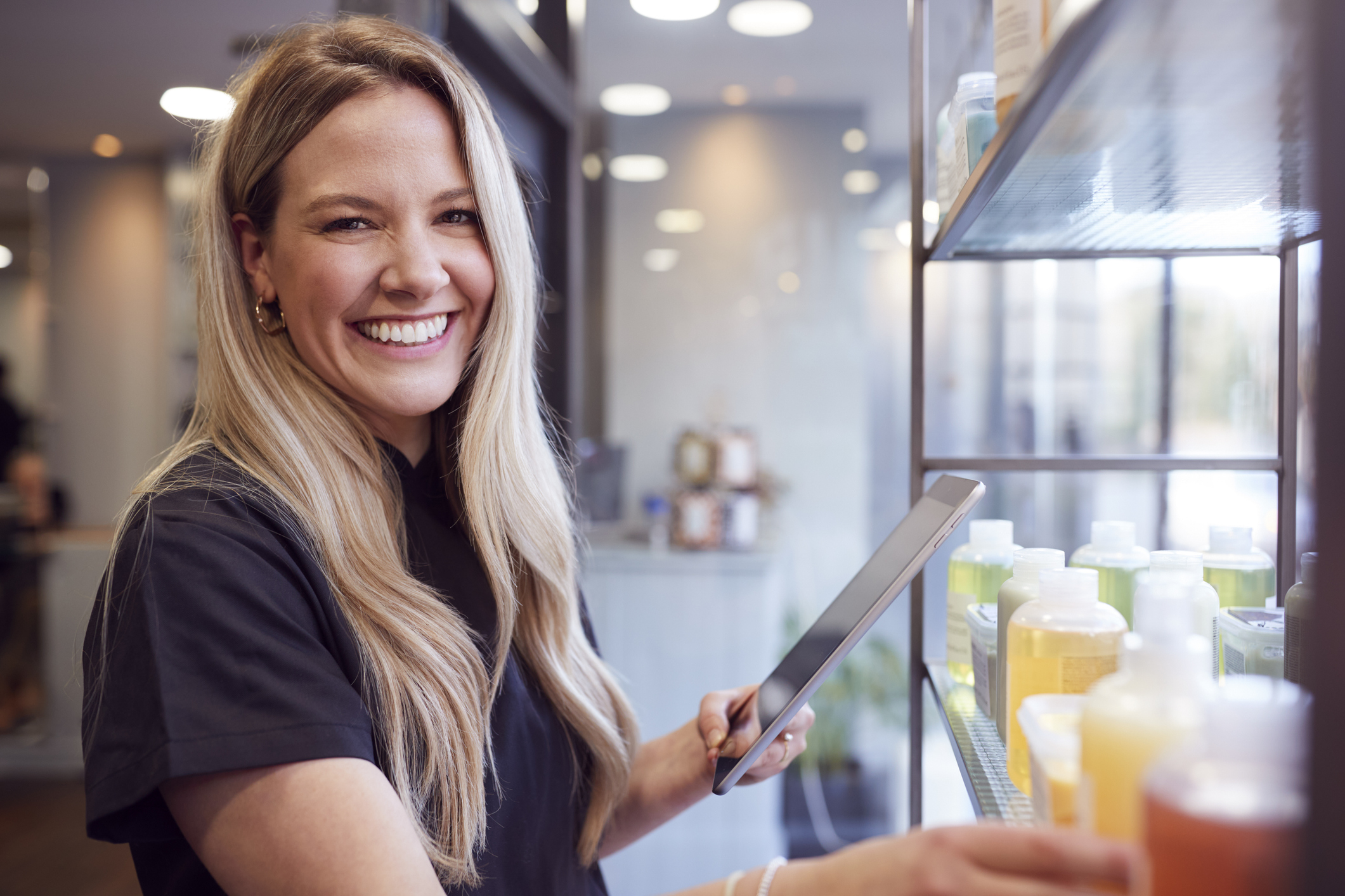 Med spa owner analyzing revenue and device options on a tablet to guide their practice's growth.