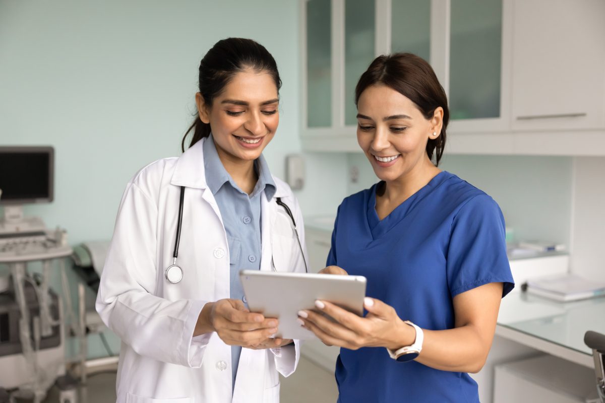 Medical colleagues reviewing patient records to build a regenerative skin care treatment menu together.